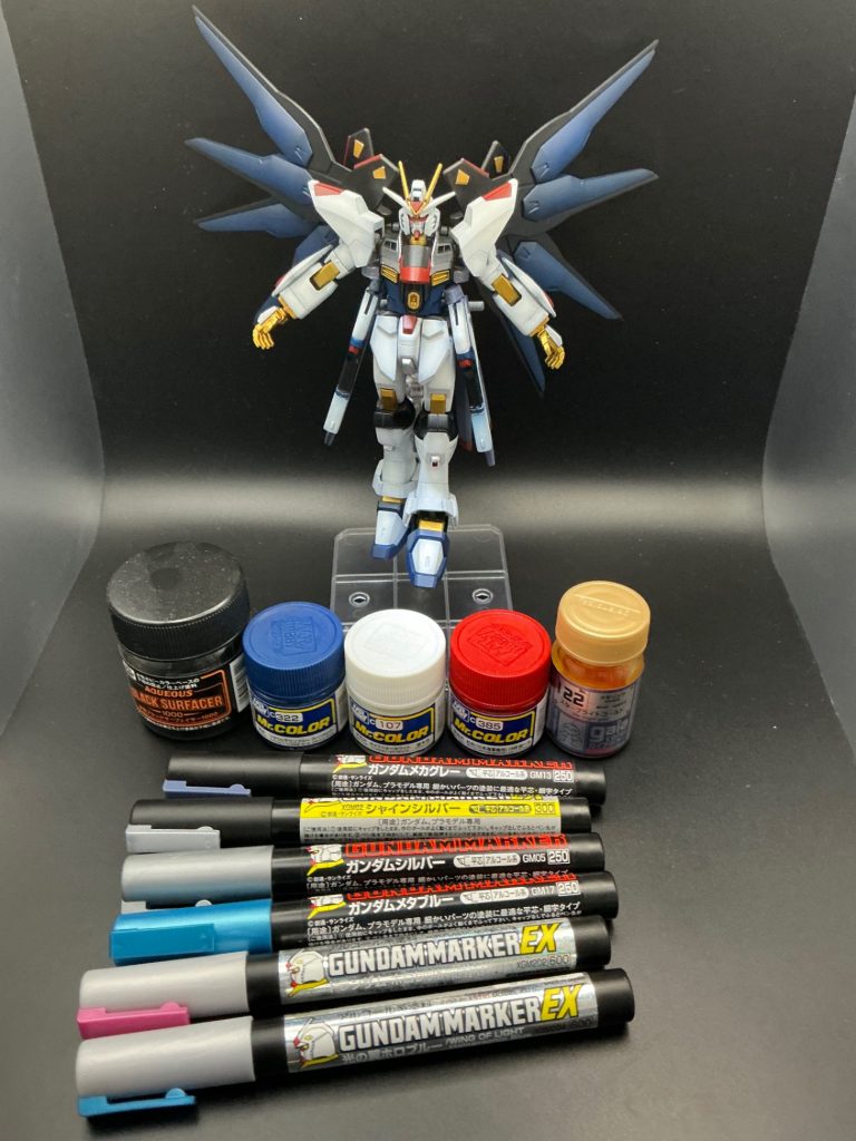 使った塗料がコチラ✨・AQUEOUS 水性ブラックサーフェイサー1000・Mr.カラー フタロシニアンブルー・Mr.カラー キャラクターホワイト・Mr.カラー 紅色（日本海軍機用）日本海軍 国旗マーク色・ガイアカラー スターブライトゴールド・ガンダムマーカー ガンダムメカグレー（ライフル、レール砲部分）・ガンダムマーカー シャインシルバー（バックパックバーニア部分）・ガンダムマーカー ガンダムシルバー（襟の部分）・ガンダムマーカー ガンダムメタブルー（センサー部分）・ガンダムマーカー トランザムホロレッド（ビームサーベル）・ガンダムマーカー 光の翼ホロブルー（シールド、ドラグーンエフェクト）&nbsp;部分塗装にガンマカ多用しました（エアブラシ洗浄しながら色使い分けるの鬼畜の所業だし、今ナフサショックのせいでツールウォッシュ手に入りにくいしね）