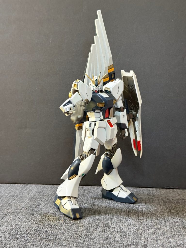 【機体解説③】完成したνガンダムは第二次ネオ・ジオン戦争終盤にロンド・ベル隊へ配備され、アムロ・レイの搭乗機として実戦投入された。本機は多数のネオ・ジオン軍モビルスーツとの戦闘で優れた戦闘能力を発揮し、最終決戦ではMSN-04 サザビーを撃破した。その後のアクシズ落下阻止作戦では、サイコフレームが人々の意思と共鳴したことで「アクシズ・ショック」と呼ばれる現象を引き起こし、小惑星アクシズを地球軌道から押し戻すという奇跡的な成果をもたらした。この戦いにより、νガンダムは宇宙世紀を代表するニュータイプ専用モビルスーツとして高く評価されることとなった。&nbsp;