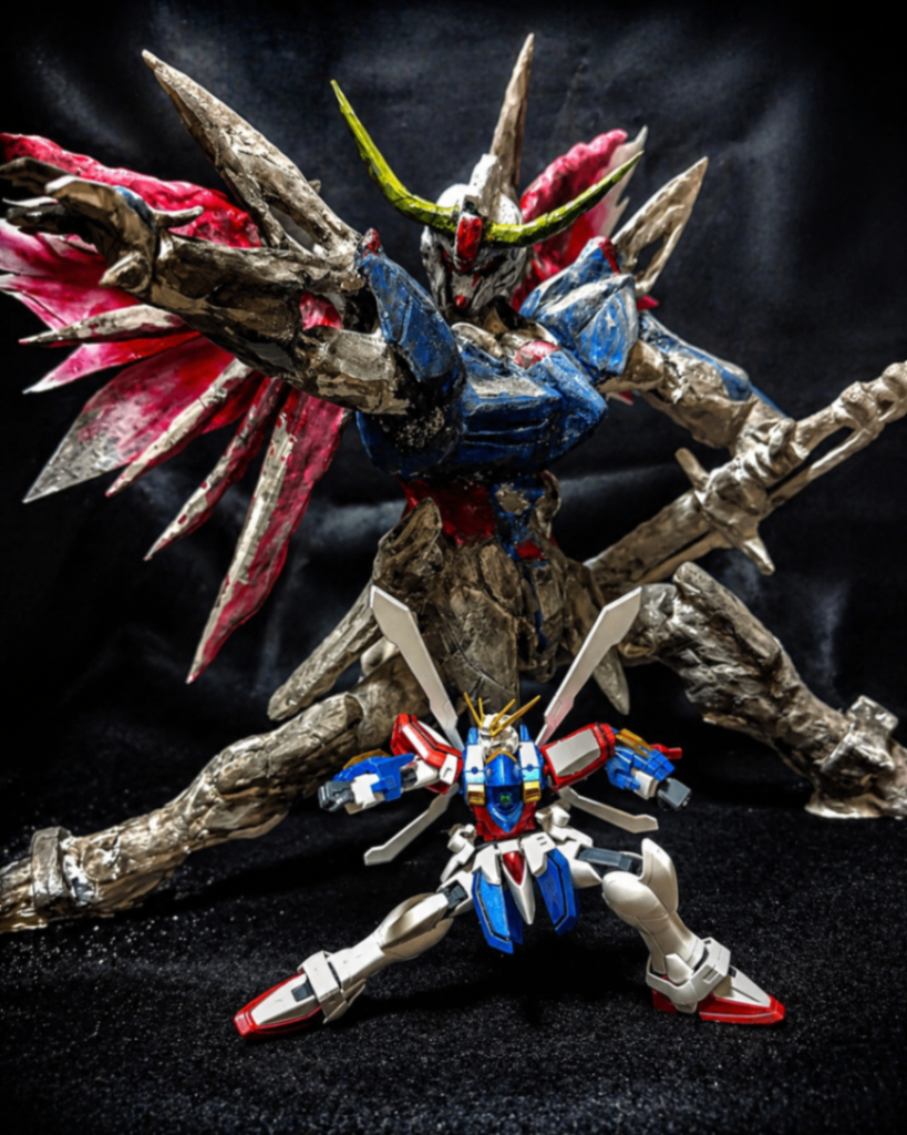 HG ゴッドガンダムとのサイズ比較手前はHG ゴッドガンダム。同じスケール感のキットと並べると、粘土造形デスティニーの全高と翼のボリュームがより伝わると思います。ベースとなるガンプラの形をなぞるのではなく、ポーズ・シルエット・翼の広がりまで含めて一体の造形として組み上げました。小さなHGとの対比で、手作りならではの圧と存在感を感じてもらえたら嬉しいです。