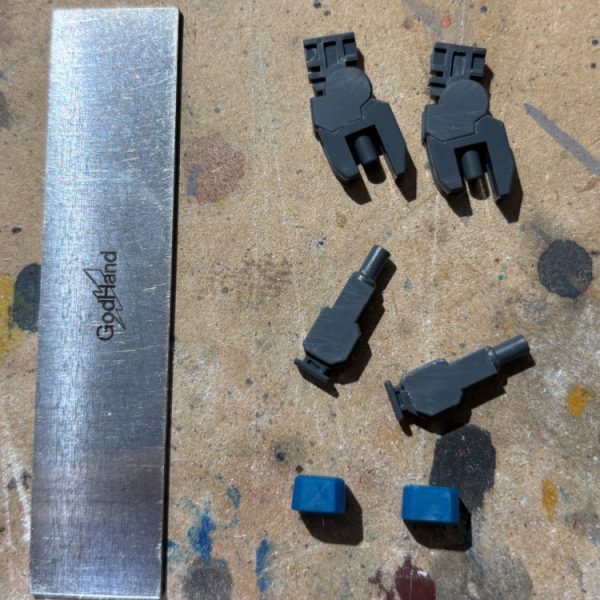 実は2週間程前からHGのガンダムX製作してます。今回は最近X（SNSの方ね）上でちょいちょい見かけるゴッドハンドのエッジ出しヤスリを積極的に使ってます。これはリニューアル前のエッジ出しヤスリでして、何年か前に便利そうだからとお高めの値段以上のリターンを夢見て購入したんですが、イマイチ使いこなせずに今までやってきました。写真で並べてあるパーツがエッジ出しヤスリで表面処理したものなんですが、どうにもヤスリ跡に引っ掻いたような細かい傷が残るもんですから、今までは結局この後に400番800番の神ヤスリで再度ヤスリがけしてたんです。正直、手間増えるだけで微妙だな(gandam2)と思ってました。で、最近になってエアブラシ使い始めたので、もしかしてサーフェイサーでこの程度の傷なら消せるのでは？と思い、やってみようと思った次第です。考えてみれば今までサフを傷消し目的として使った事無かったですわい(zaku-kao9)結果は次回の投稿にて！