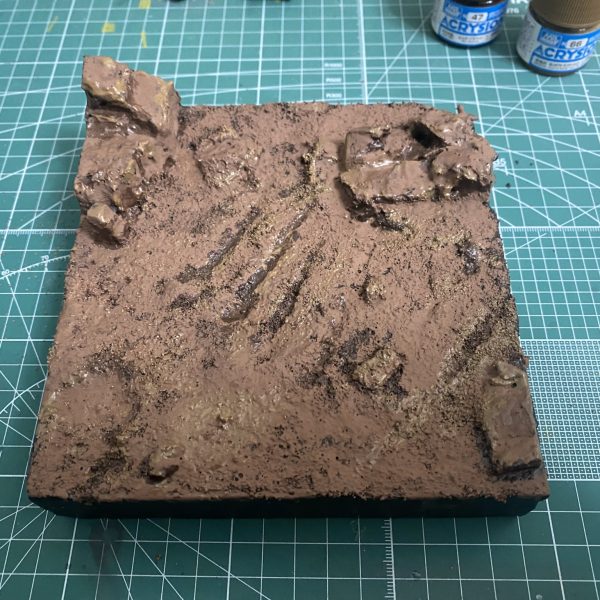 ①スタイロフォームを削って形にして②造形ベースで目止めぺたぺた③下地黒をぺたぺた④薄めたボンドぺたぺた、バラスト(ナノ)ぺたぺた、アクリジョン(焦茶、茶、薄茶)ぺたぺた⑤つや消し+プランツシートちぎってぺたぺた、サバゲーの人たちを配置、戦車も配置ザクはどこに置こうかしら🤔（5枚目）