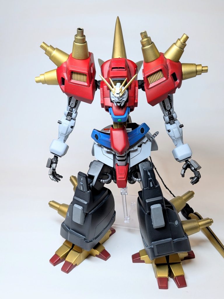 ［ゴッドガンダムとの戦いに敗れたデビルガンダムが、質量の増大ではなくゴッドガンダムのように１個体のMFとしての強さを極限まで高める方向性で自己進化した姿］という設定で作成しました。名前は、デビルガンダムの前身であるアルティメットガンダムを使わせてもらいました。