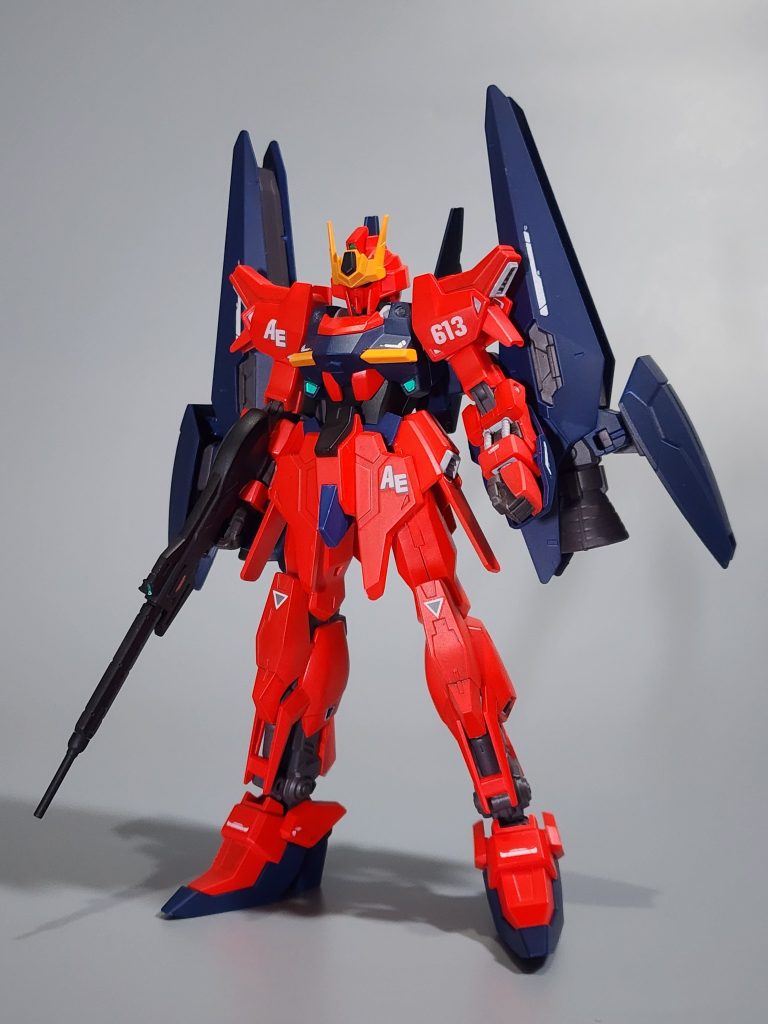 The base kit for this custom kitbash is the HGBF Lunagazer Gundam, with the rifle and booster packs from the HGBD Tertium Gundam and Tertium Arms option set, respectively.