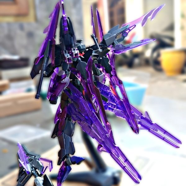 This time, I wanted to develop the Gundam AGE-2 into an antagonist Gunpla that I imagined as a true rival for the Wing Gundam Zero Honoo.After reading Gundam Build Fighters Honoo Try, I became interested in the idea of a Gunpla having a strong identity and character as a rival. From there, I tried to create my own interpretation.The base is the Gundam AGE-2, combined with parts from the HG Transient Glacier, Option Weapon Joker, and a halberd/spear-type weapon as its main weapon.While building it, I focused not only on the appearance but also on joint compatibility and mechanical continuity between the different parts. This approach was inspired by the mechanical design style of Kanetake Ebikawa, making the different components feel integrated rather than simply attached together.For the overall concept, I was inspired by Dark Rebellion Xyz Dragon from Yu-Gi-Oh! ARC-V. I really like how the monster combines a dark, sharp, aggressive, yet elegant appearance.I wanted to translate those characteristics into a mobile suit:Dark + Sharp + Aggressive + Elegant.For me, the goal of this custom is not simply to make an AGE-2 with additional parts, but to create a Gunpla with its own identity as an antagonist and a worthy rival to Wing Zero Honoo.Base: Gundam AGE-2Additional Parts: HG Transient GlacierAdditional Weapons: Option Weapon Joker + Halberd/SpearConcept: Dark Rebellion Xyz Dragon × Gundam AGE-2Design approach: Joint compatibility & mechanical continuity(3枚目)