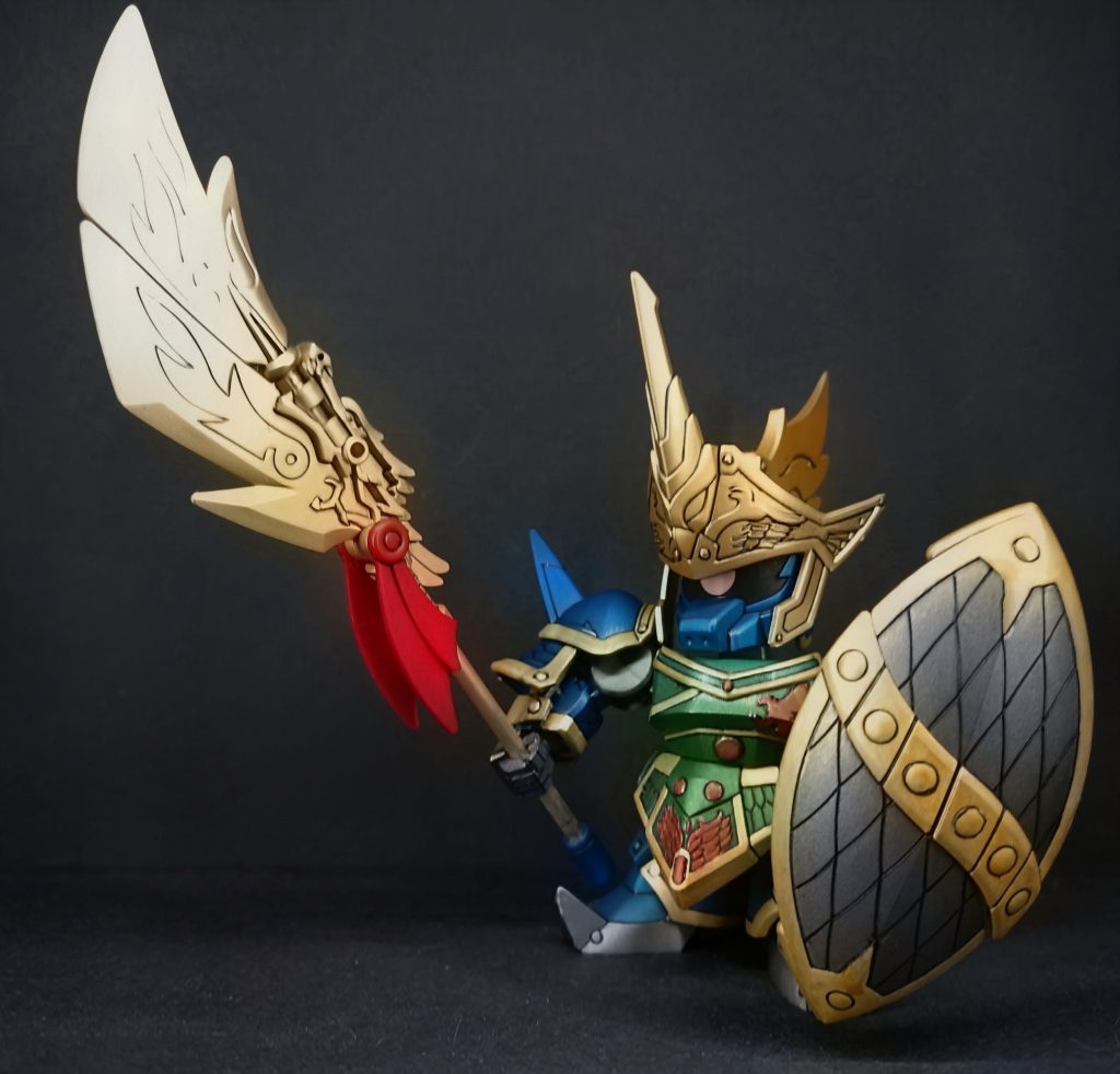 ​【作中での概要】​「SDガンダム三国伝」に登場する、呂布隊の副将を務める猛将。演者は『機動戦士ガンダム0083 STARDUST MEMORY』に登場する「ガトー専用ゲルググ」。​呂布トールギスに劣らぬ圧倒的な勇猛さを誇り、天下にその名を轟かせる「泣く子も黙る」豪傑。主である呂布からの信頼も厚く、敵対する曹操ガンダムや関羽ガンダムからも一目置かれる実力者である。 &nbsp;​作中では呂布隊の副将として、その圧倒的な武力と凄絶な闘魂で戦場を席巻。ただの戦闘狂ではなく、武人としての誇りや義理堅さを秘めた生き様が描かれ、物語に重厚な魅力を加える存在となっている。
