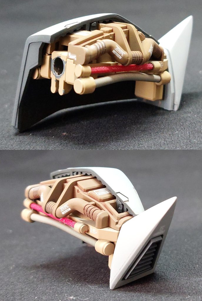 ■肩アーマー 内部メカにφ2.0mmのスプリングやφ1.5mmの赤いチューブを取り付け、ディティールを追加しました。スプリングの内部には針金を通しており、フレキシブルに曲げて形状を維持することができます。スプリングとチューブの両端には、コトブキヤのモデリングサポートグッズ「プラユニットモビルパイプ」を取り付けました。 また、ゲルググ特有の四角錐のトゲ?は、周囲を削り込んで先端を鋭角化しています。肩のトゲがシャープだと、完成後の全体的な印象が引き締まります。 左肩アーマーは中央線で切り離して内部フレームを露出させており、断面にエバーグリーン製の凹凸プラ板を細切りにして貼付け、複合的な装甲の表現を行いました。