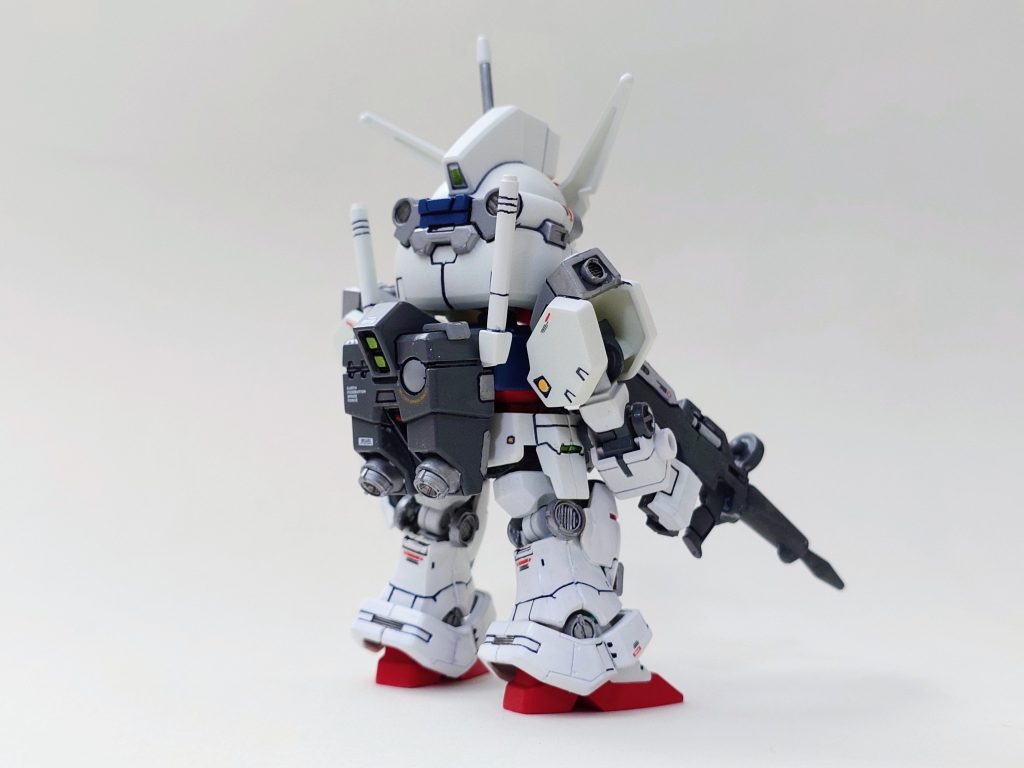 今回の改造では、SDCS の RX-78 キットをベースに使用しました。肩以外の腕部は RX-78 のパーツをそのまま流用し、脚部は RX-78 のフレームに RG のパーツを切り出して組み合わせています。顔については、元のパーツを削り込んで調整し、目を小さく、マスクを内側に押し込むことで、少し精悍な印象になるよう工夫しました。一番頭を悩ませたのはシールドでした。SD キットのシールドは頭部よりも小さく、HG のものは逆に大きすぎるため、最終的にはプラ板で自作するしかありませんでした。形を整えるのに苦労しましたが、水転写デカールを加えることで、他のパーツとの精密さの違いを少しでも緩和できるようにしました。