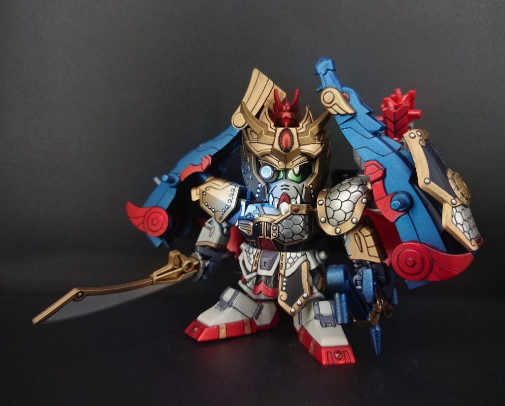 【作中での概要】黄忠ガンダムは、『三国志』の名将・黄忠をモチーフにしたガンダム作品のキャラクターで、三国志の武将をモビルスーツ風にアレンジした「SDガンダム三国伝」シリーズなどでは、武将ごとの個性が機体デザインや武装に反映されています。黄忠といえば、弓の名手として知られる老練な武将。そのため、ガンダム作品でも弓を使った遠距離攻撃が大きな特徴になっています。基本プロフィール登場作品: 『SDガンダム三国伝 』関連シリーズモチーフとなった武将: 黄忠(字は漢升)演者: スーパーガンダム特徴: 老練な戦士で、射撃を得意とする所属: 翔(ショウ)の国立ち位置: 五誇将(ごこしょう)の一人 ※要約ChatGPT