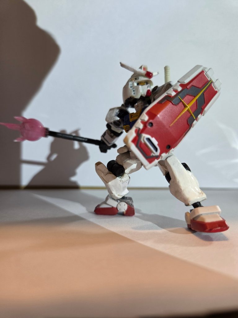 シールド、ビームジャベリンア「これも元のガンダムにあった武装だ。」先生「何で背中に刺さってた小さい棒がここまで長くなるんです?」ア「ああ、それは護身用の伸縮警棒と似ていて、遠心力を検知するマイクロセンサーが、サーベルグリップに内蔵されていて、そのセンサーが機能すると、内部に格納されている中空のシャフトが伸びてこの形になるらしい。」先「強度は大丈夫なんですか?」ア「シャフト内面に、ミノフスキー粒子加速器が装着されていて、シャフトの中を、ビームが流れているから、強度はある程度あるんだ。ジャベリンのビーム部分が丸いのは、俺も良く分からないが、シャボン玉と似ている仕組なのかもな。」
