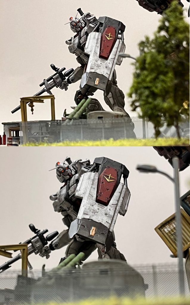 樹木、街灯、アルミフェンス、トラック越しのガンダム。遠近法でMSの巨体を演出できます。